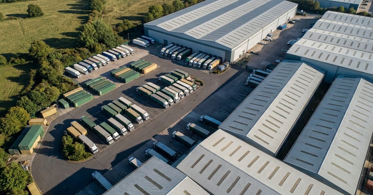 A food distribution yard and warehouse roofs, seen from high above in daylight