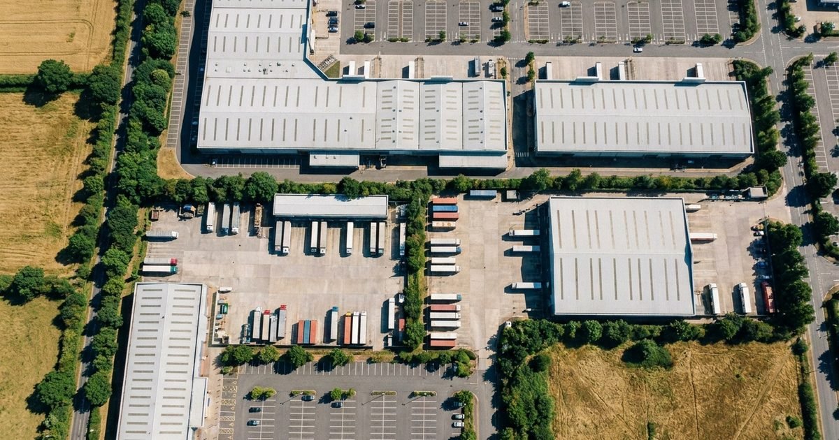 A retail park and its service yards, seen from high above in daylight